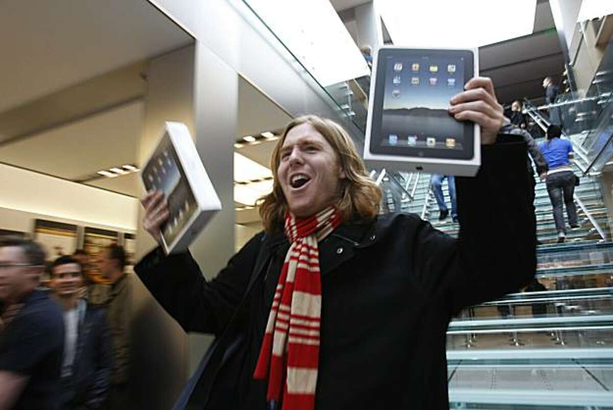 In this file photo taken April 3, 2010, Andres Schobel holds up two iPads as one of the first customers to buy iPads on the first day of Apple iPad sales at an Apple Store in San Francisco. Apple said Monday, April 5, it sold more than 300,000 iPads on Saturday, the day it debuted across the country.
