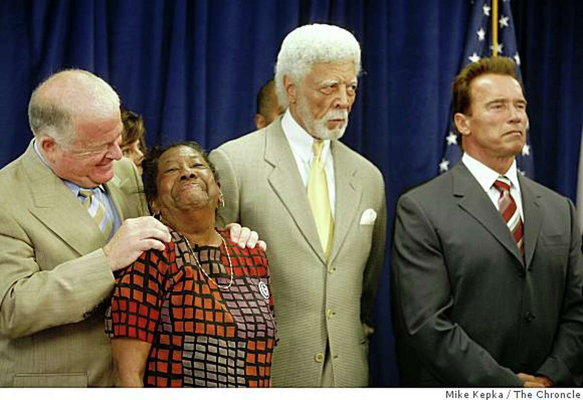 With Oakland's Mayor Ron Dellums and Governor Arnold Schwarzenegger to her right, Dorothy Hicks of Oakland receives a hug from Senate President pro Tem, Don Perata during a press conference at The Unity Council building on Tuesday July 8, 2008 in Oakland, Calif. where the governor later signed a foreclosure bill called SB1137. Hicks who's home was in foreclosure over a year ago pleaded her case in front of the state senate in Sacramento which kick started Perata's foreclosure bill.Photo by Mike Kepka / The Chronicle