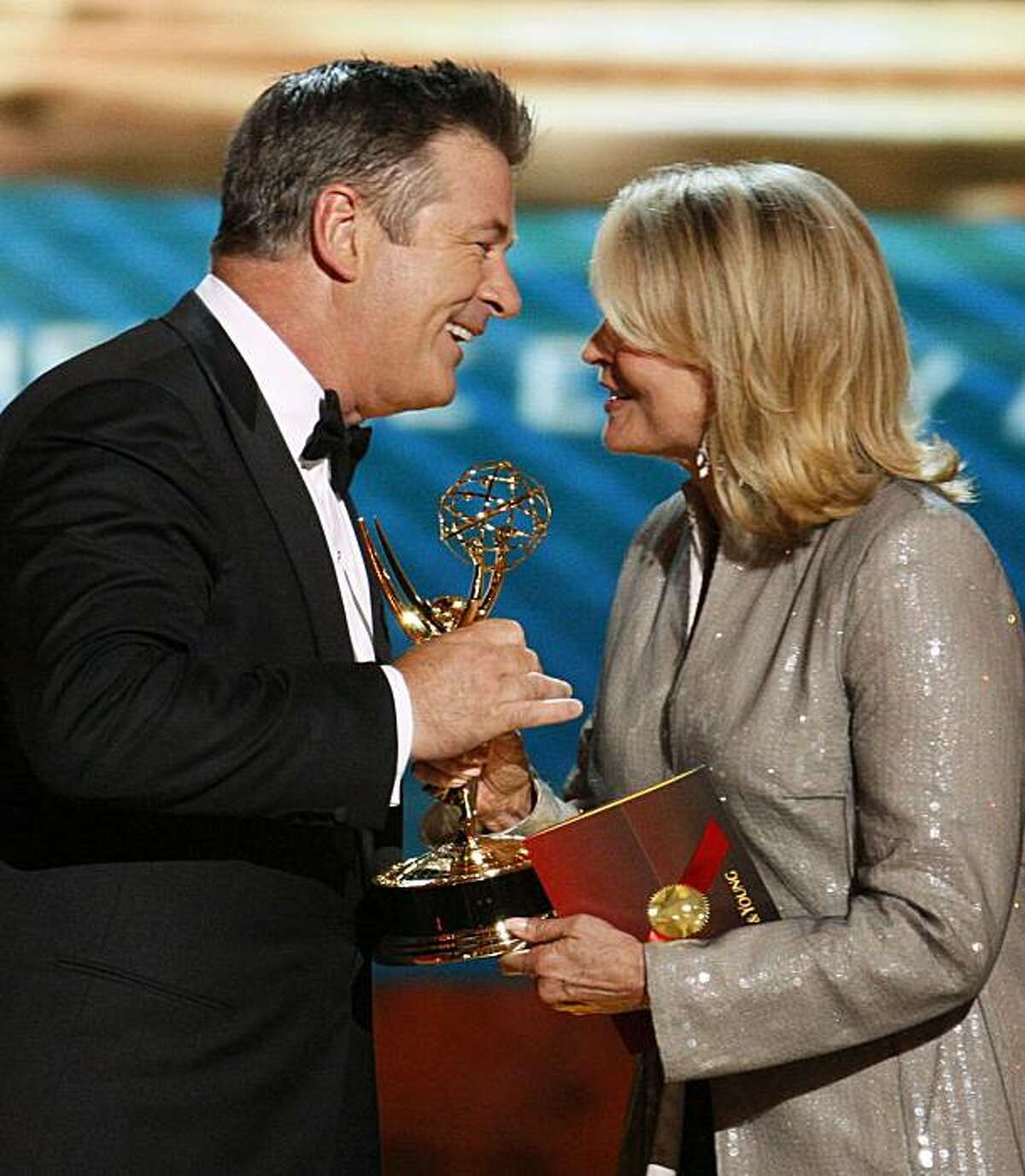 Actor Alec Baldwin accepts the award for outstanding lead actor in a comedy series for "30 Rock" from presenter Candice Bergen at the 60th annual Primetime Emmy Awards in Los Angeles September 21, 2008. REUTERS/Lucy Nicholson (UNITED STATES)