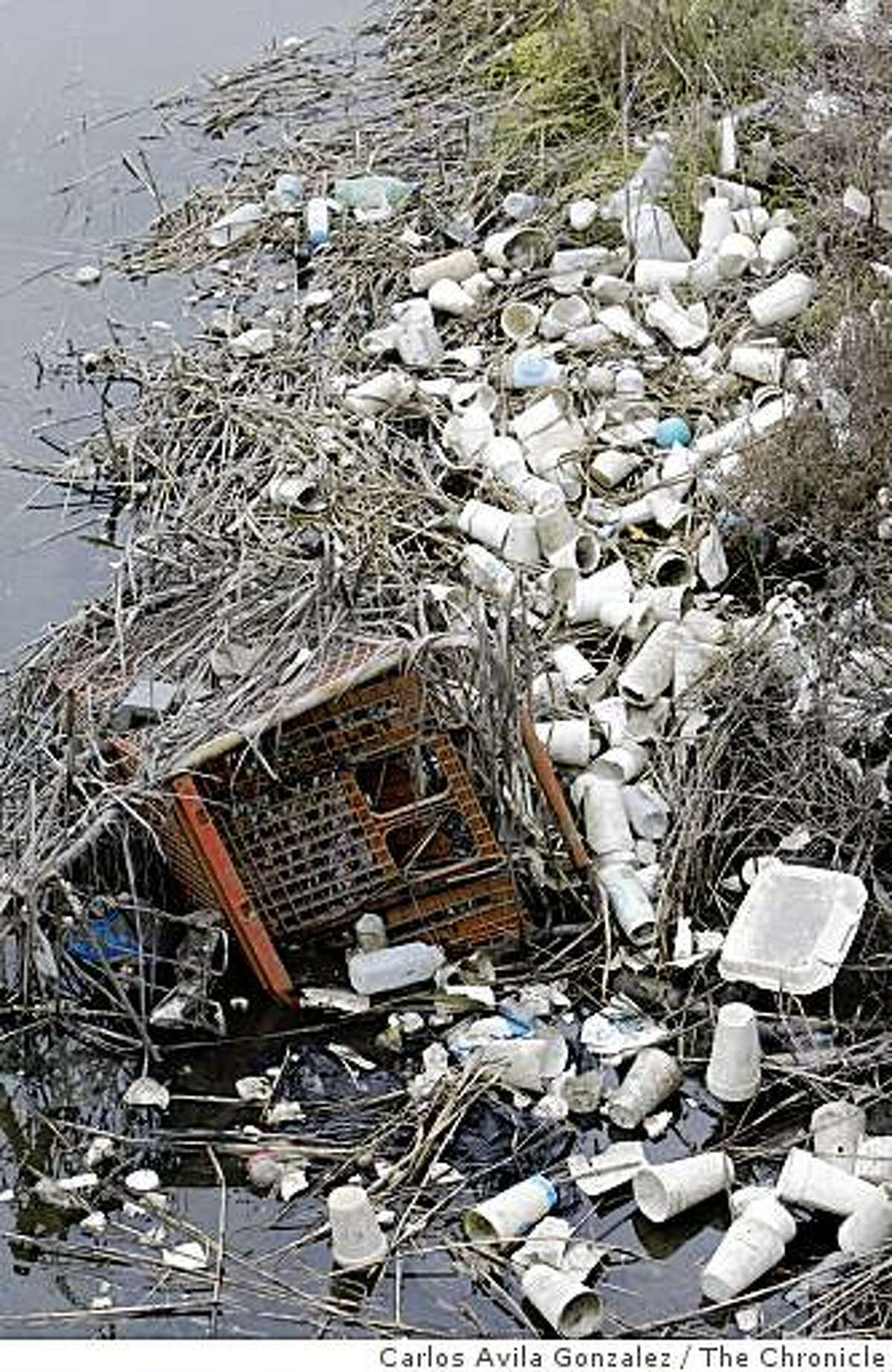 Trash lines the shores of Damon Slough near the McAfee Coliseum and Highway 880 on Wednesday, September 17, 2008. Saturday is the annual Coastal Cleanup day. Save the Bay considers Damon Slough in Oakland to be one of the worst trash hotspots in the Bay Area.