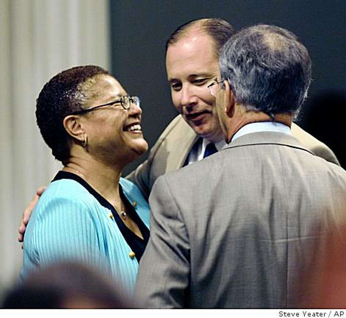 Assembly Speaker Karen Bass, left, D-Los Angeles, talks with Assembly Minority Leader Mike Villines, R-Clovis, center and Assemblyman Roger Niello, R-Fair Oaks, right, after the Assembly voted to pass the state budget at the Capitol in Sacramento, Calif., on Friday, Sept. 19, 2008. (AP Photo/Steve Yeater)