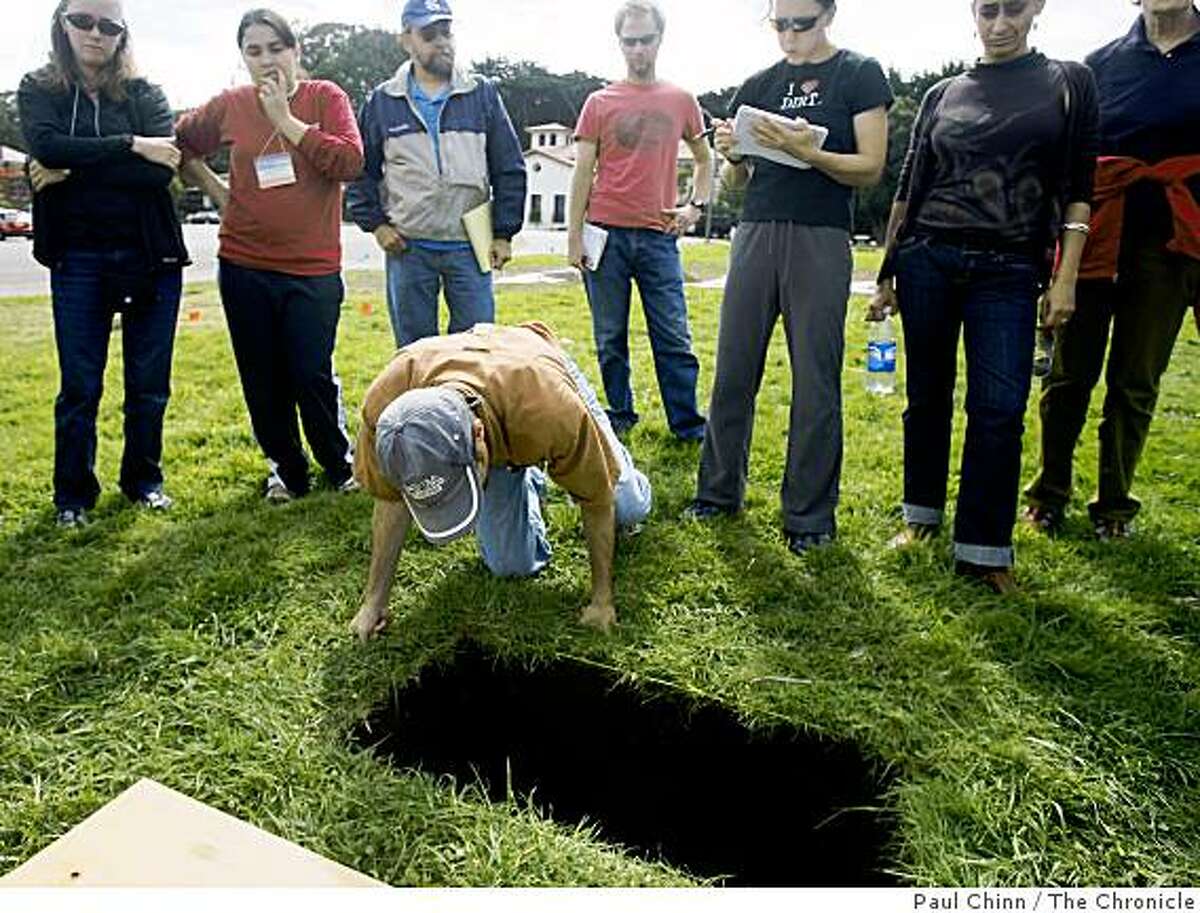 Ian Lindsay gets a close-up view of an excavation site with other archeologists at the Presidio in San Francisco, Calif., on Friday, Sept. 19, 2008.