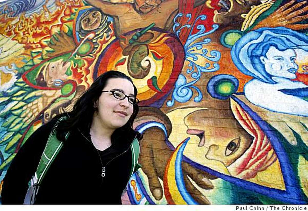 Carolyn Zola walks past a mural created by the Precita Eyes Muralists at 24th and Mission streets in San Francisco, Calif., on Thursday, Sept. 11, 2008. A political consultant finds that the neighborhood Zola where lives is the most liberal voting block in the city.