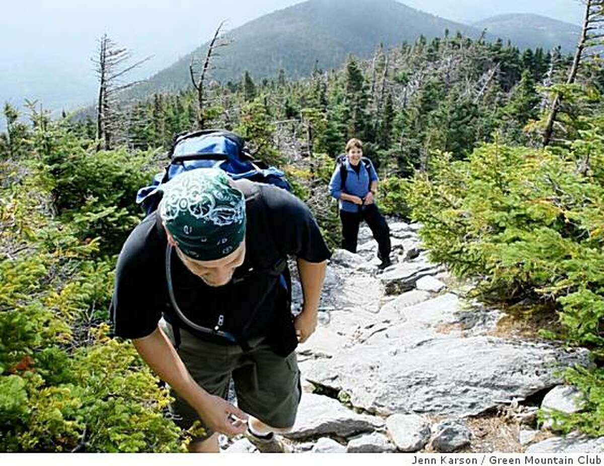 Laura Hardy and Alan Perry climb a ridge on the Monroe Skyline, a section of the Long Trail near Mount Abraham.