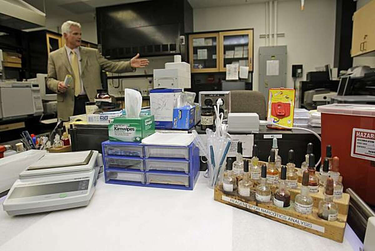 Lab director Jim Mudge shows criminalist Deborah Madden's work station at the police crime lab in San Francisco on Wednesday, March 10, 2010. Madden is accused of stealing cocaine last year that was used as criminal evidence by prosecutors. San FranciscoPublic Defender Jeff Adachi said the allegations could affect "hundreds if potentially thousands of cases."