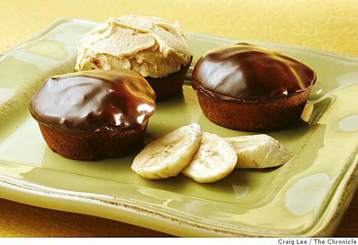 Banana cupcakes with two types of frosting, chocolate glaze and peanut butter, in San Francisco, Calif., on August 22, 2008. Food styled by Audrey Sherman.