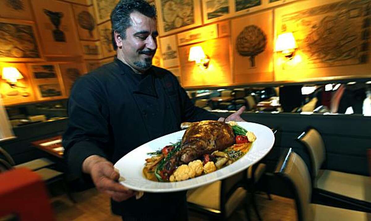 Owner-Chef of Zare at Fly Trap restaurant in San Francisco, Hoss Zare carries a leg of lamb into the dinning room that was prepared for the Persian New Year feast. Thursday March. 4, 2010