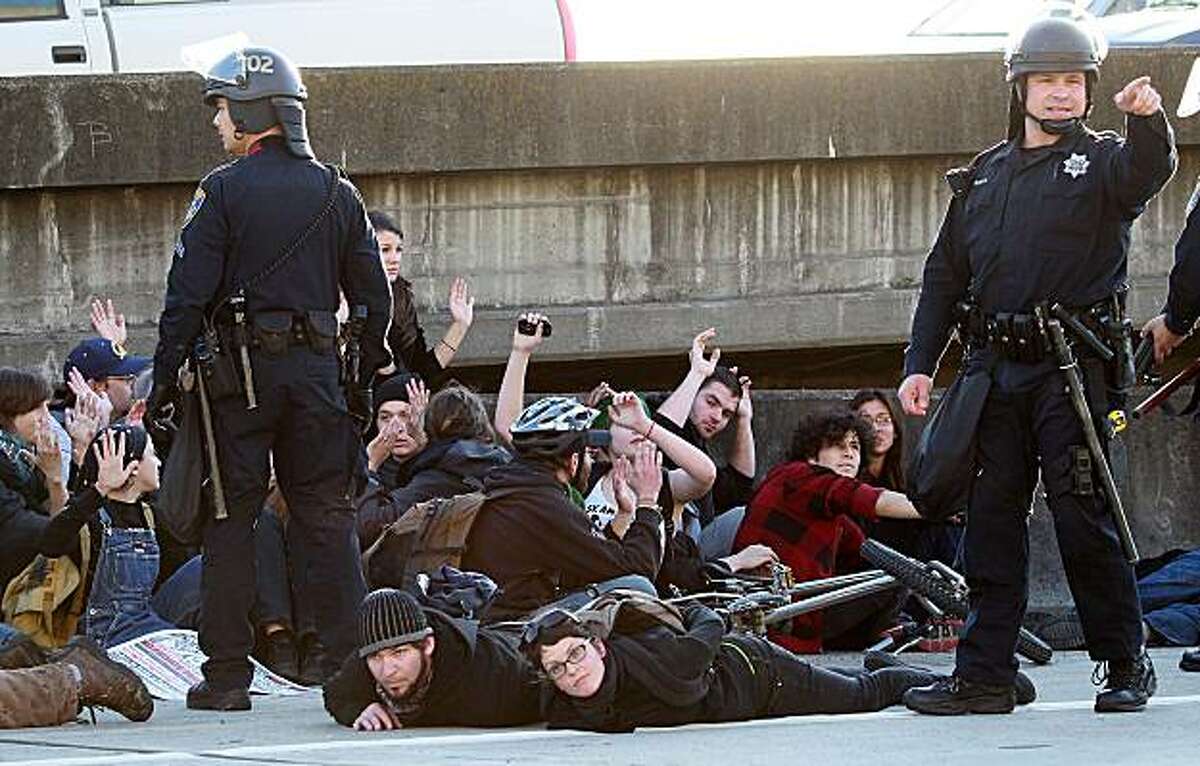 OAKLAND, CA - MARCH 04: Oakland police officers arrest a group of protestors that attempted to block Interstate 880 following a rally for the national day of action against school funding cuts and tuition increases March 4, 2010 in Oakland, California. Dozens of protestors were arrested after they stormed the 880 freeway as students across the country are walking out of classes and holding demonstrations against massive tuition increases and funding cuts to college universities.