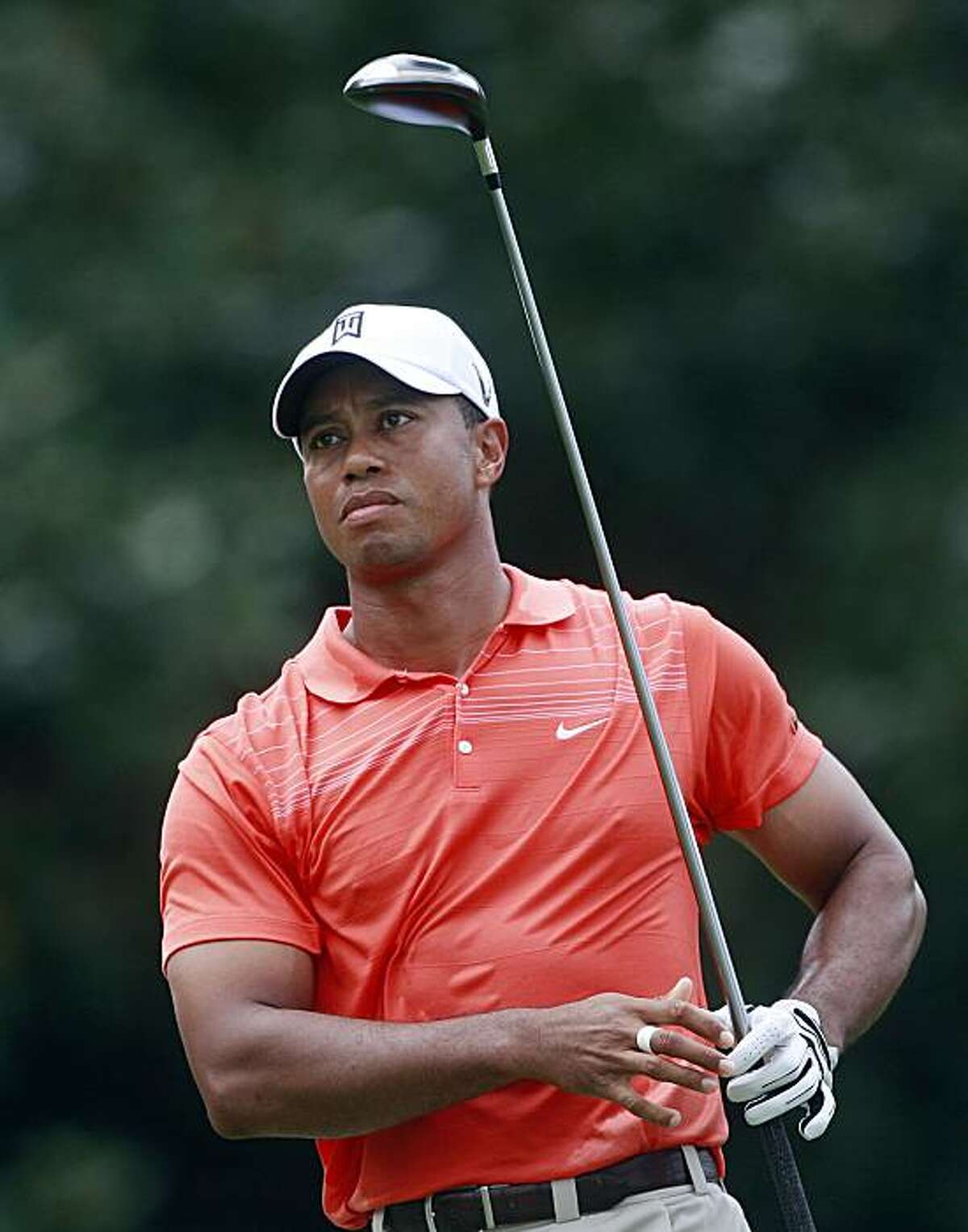 FILE - This Sept. 25, 2009, file photo shows Tiger Woods watching his tee shot on the fifth hole during the second round of the Tour Championship golf tournament at the East Lake Golf Club in Atlanta. Woods is back at home after a week of family counseling in Arizona and is trying to get back into a routine that includes golf and fitness, according to a person with knowledge of his schedule.
