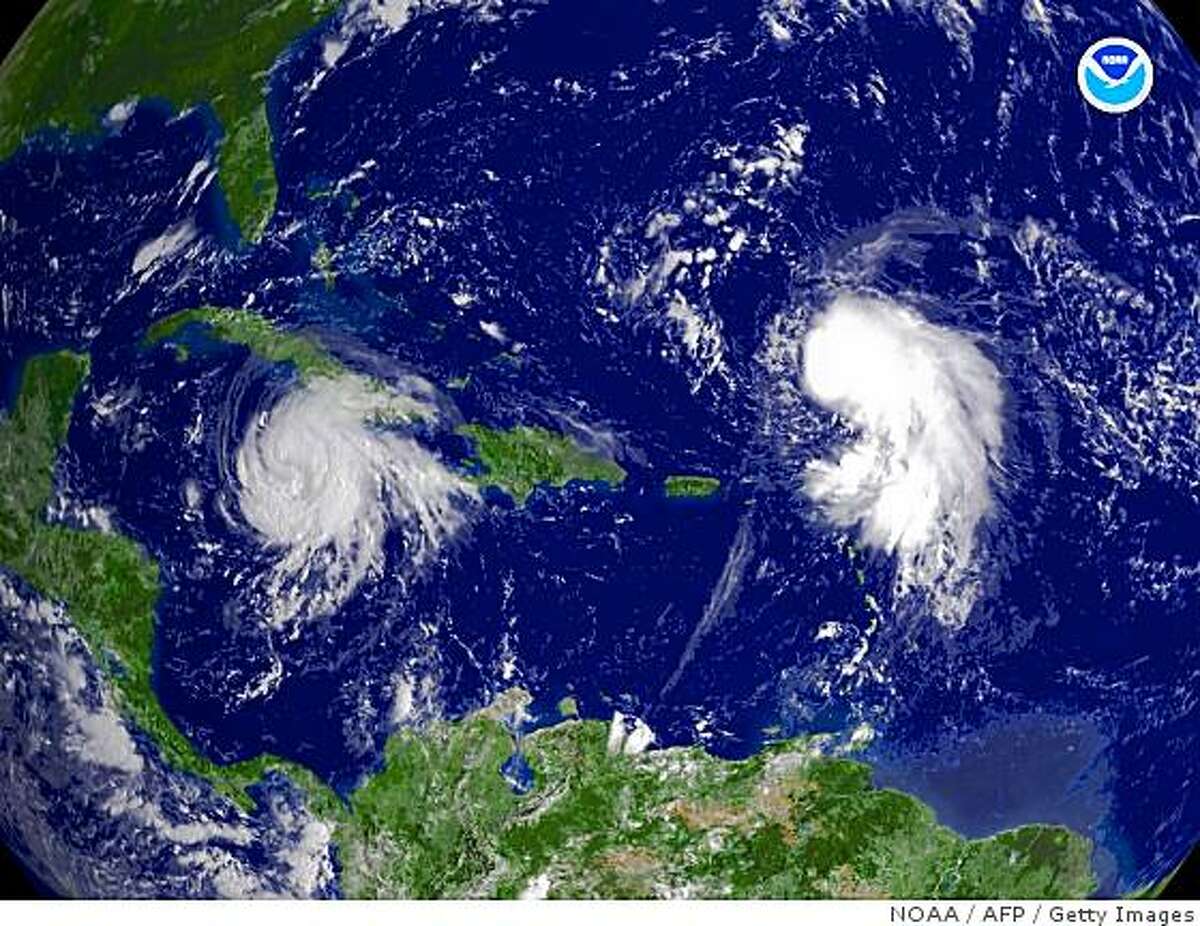 This August 29, 2008 NOAA satellite image shows Tropical Storms Gustav (L) and Hanna(R). Deadly Tropical Storm Gustav thrashed Jamaica on August 29 and was on track to crash into Cuba as a hurricane, after leaving up to 78 people dead in the Dominican Republic, Haiti and Jamaica. The United States began storm preparations as Jamaica awoke to a trail of devastation and reports that the storm killed as many as 11 people on the mountainous island. Churning Gustav moved west, triggering flash floods and driving rains and could become a "major hurricane" before reaching western Cuba on the weekend, the US National Hurricane Center warned. Meanwhile Tropical Storm Hanna was churning north-northeast of the northern Leeward Islands, and could become a hurricane in a few days, the National Hurricane Center said. AFP PHOTO/NOAA/HANDOUT =GETTY OUT= (Photo credit should read HO/AFP/Getty Images)
