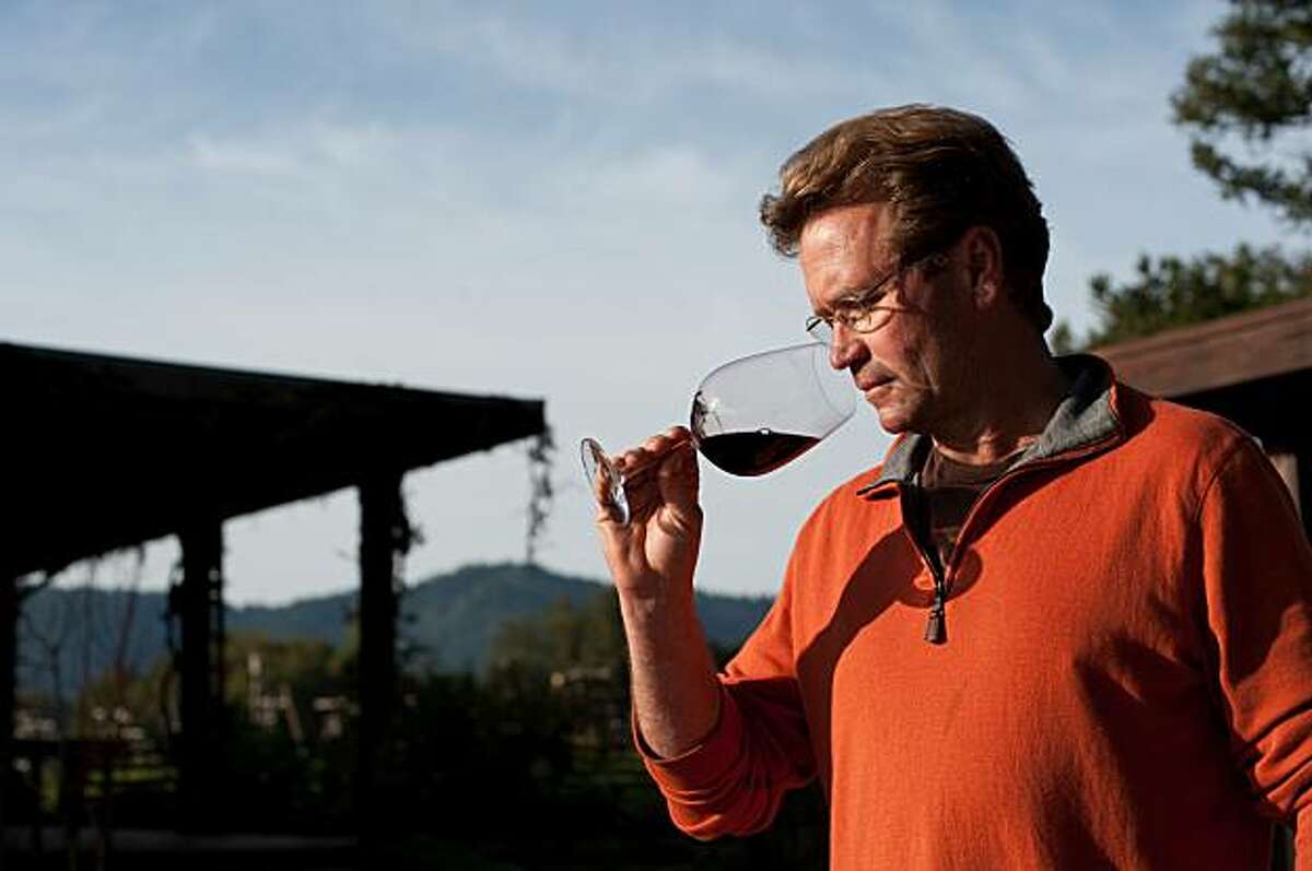 Mount Eden Vineyards owner Jeffrey Patterson smells a glass of his Cabernet Sauvignon outside of his home on Wednesday, February 18, 2010.