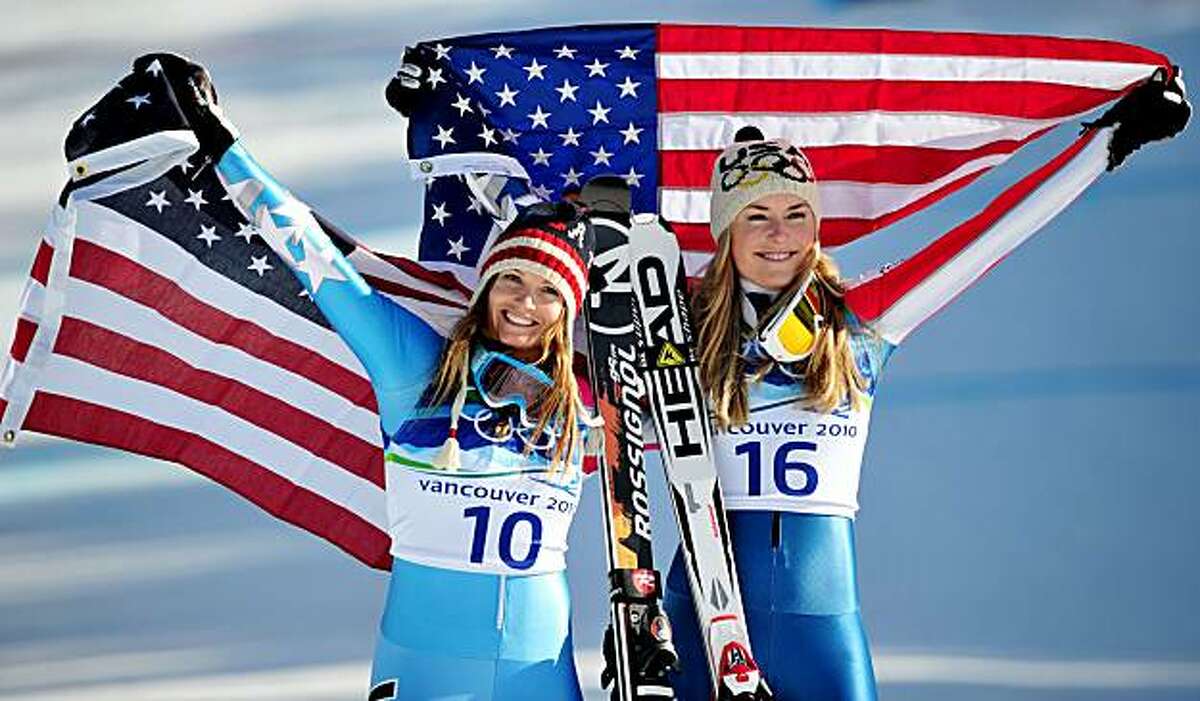 WHISTLER, BC - FEBRUARY 17: Julia Mancuso (L) of the United States celebrates winning silver and Lindsey Vonn of the United States gold during the flower ceremony for the Alpine Skiing Ladies Downhill on day 6 of the Vancouver 2010 Winter Olympics at Whistler Creekside on February 17, 2010 in Whistler, Canada.