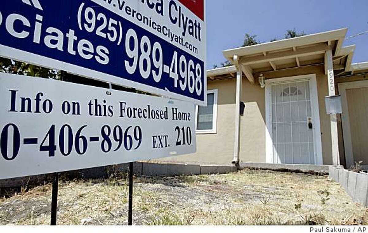 A sign in front of a foreclosed home is shown in Antioch, Calif., Thursday, Aug. 14, 2008. The number of homeowners stung by the dramatic decline in the U.S. housing market jumped last month as foreclosure filings grew by more than 50 percent compared with the same month a year ago, according to data released Thursday. (AP Photo/Paul Sakuma)