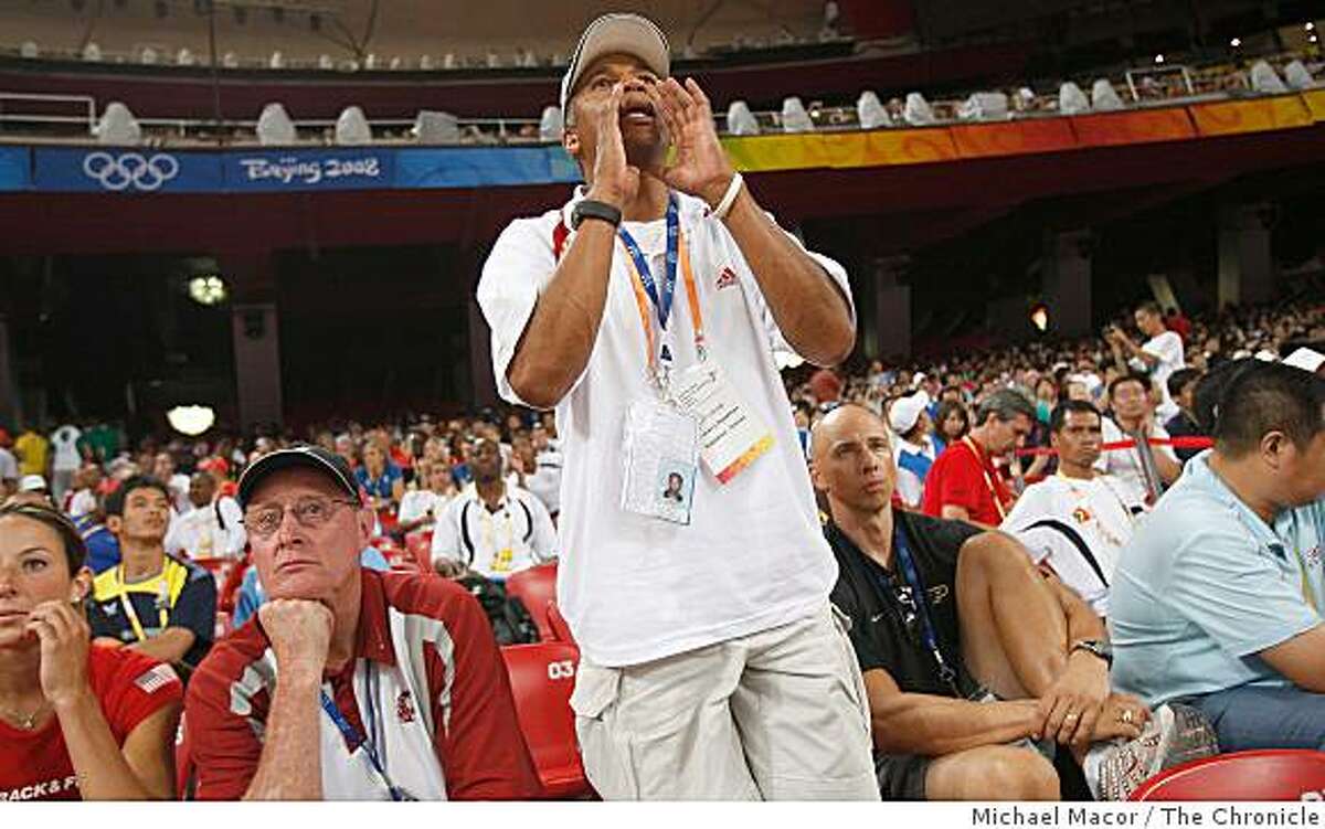 Heptahlon coach Lynn Smith, shouts directions to his heptahlon athlete from the stands during on the opening day of athletics competitions, on Friday Aug. 15, 2008 at the Olympic Games in Beijing, China.