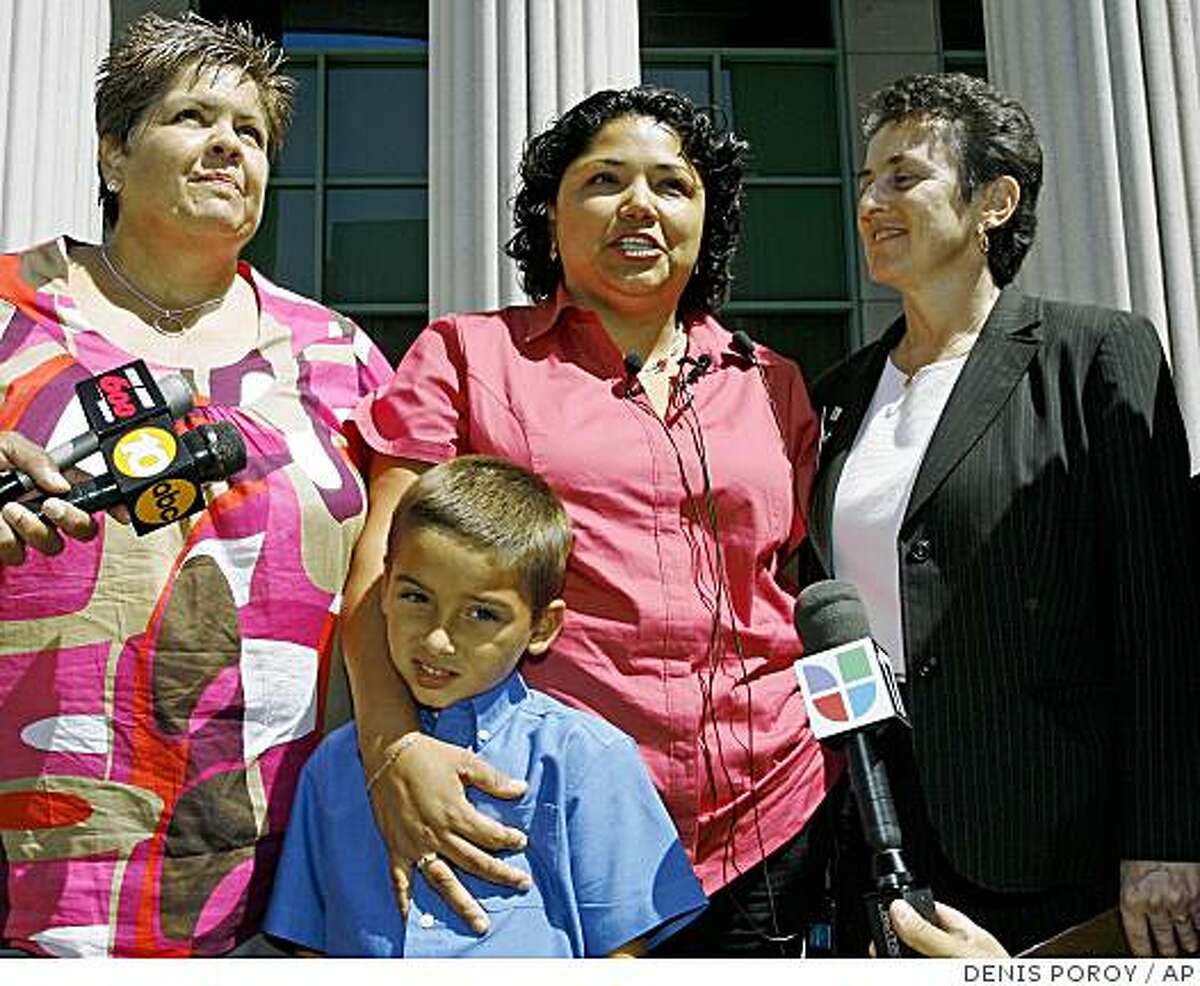 Guadalupe Benitez, center, speaks next to her partner Joanne Clark, left, her son Gabriel Clark-Benitez, foreground, and her attorney Jennifer Pizer, right, at news conference held at the Hall of Justice in downtown San Diego Monday, Aug. 18, 2008. The California Supreme Court ruled Monday that Benitez, a lesbian, was unfairly denied a common infertility treatment by doctors at the North Coast Women's Care Medical Group based on their religious beliefs. (AP Photo/Denis Poroy)
