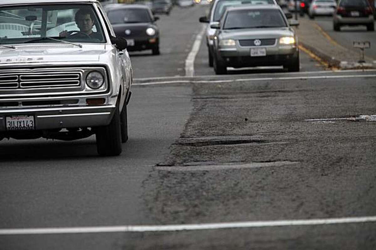 Cars headed over a pot holes and cracked road at Route 185 (Mission Blvd) on Wednesday, Dec. 16, 2009 between San Leandro and Hayward, Calif. The Bay Area's roads are the worst in the country topped only by roads in Los Angeles.