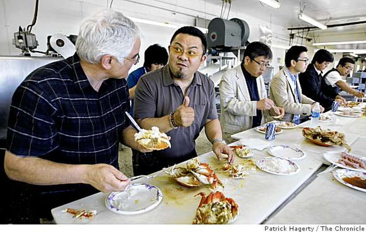 Wild Planet co-founder and president, Bill Carvalho, left, gets a "thumbs up" from Osamu Shimizu, of Shizuoka, Japan, second from left, as they eat a lunch of fresh dungeness crab, from Prince Rupert, British Columbia and albacore tuna from Newport, Ore., Thursday, July 24, 2008, at Dungeness Development, a custom cannery, processor and packaging facility in South Bend, Wash. Shimizu was with a group of Japanese seafood distributors making an annual visit to seafood suppliers. (Others in the photos are: Yusuke Shimizu, behind, Hisakazu Imoto, third from left, Hiroaki Kawasumi, third from right, Yasuhiro Suzuki, second from right and Takashi Nasa, far right.)