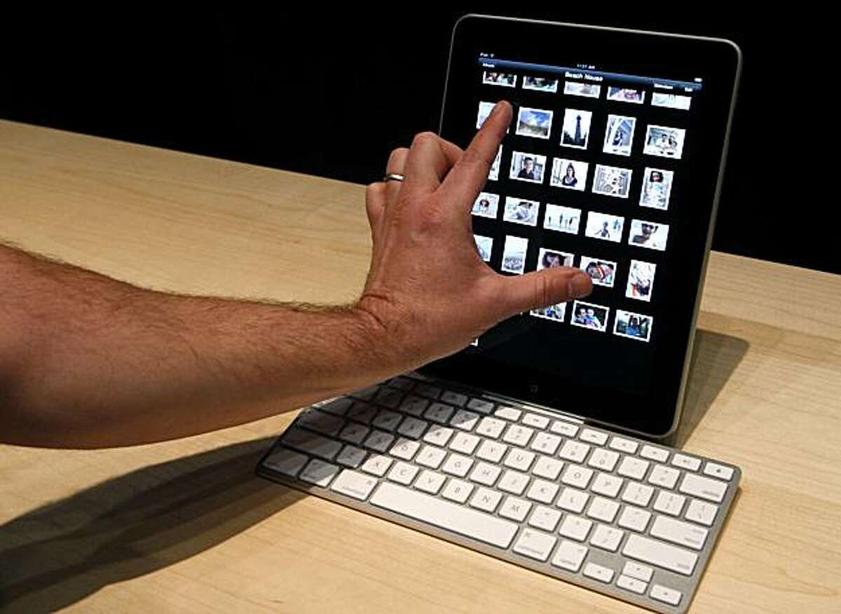 An Apple employee demonstrates the new iPad after CEO Steve Jobs unveiled the tablet-style gadget at the Yerba Buena Center for the Arts.