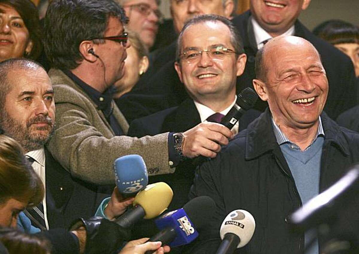 In this Sunday, Dec. 6, 2009 photograph parapsychologist Aliodor Manolea, left, with beard, is seen next to Romania's President Traian Basescu, right. Manolea specialties include deep mind control, clairvoyance and hypnotic trance, according to the Romanian Association of Transpersonal Psychology.