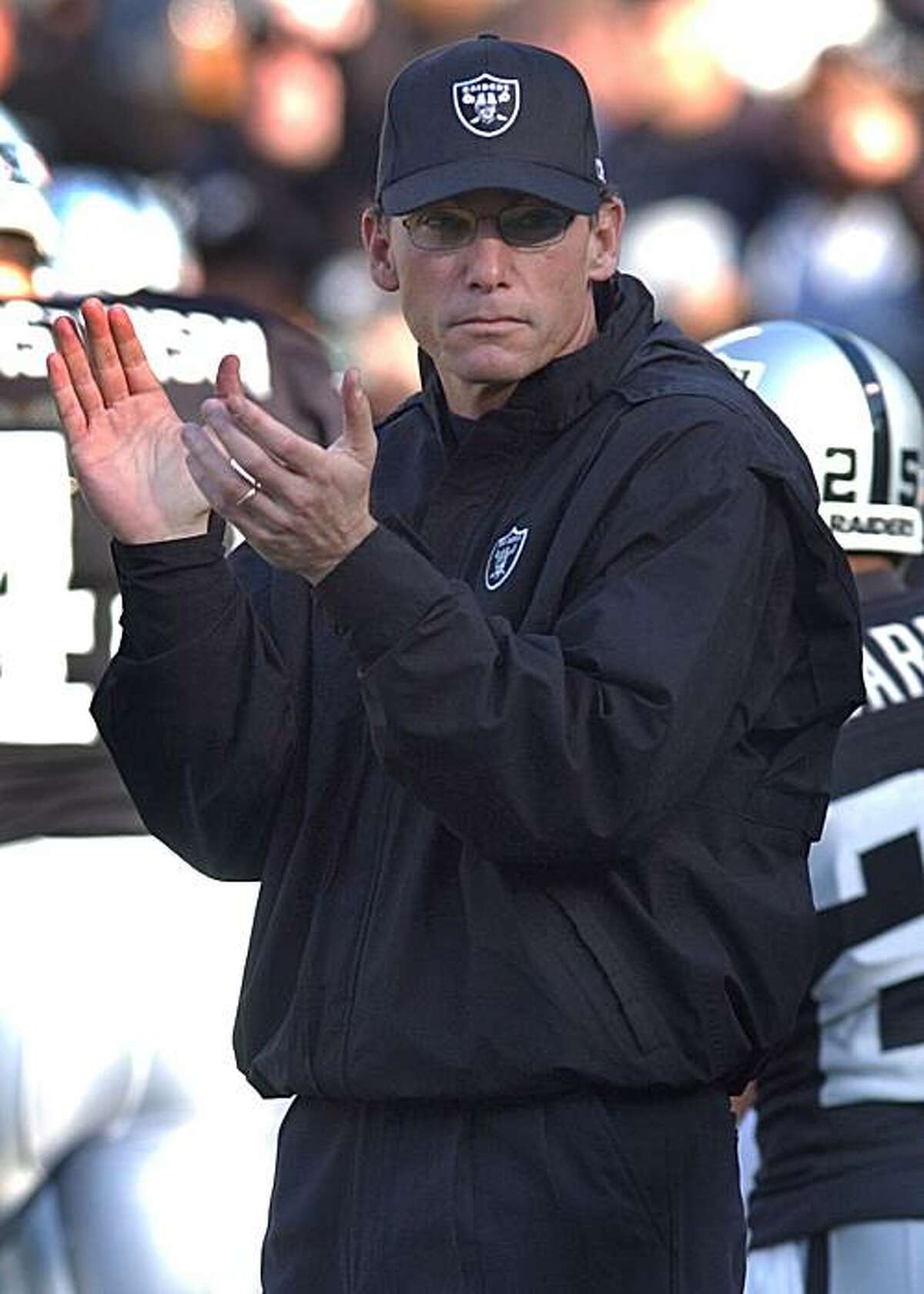 ** FOR USE ANYTIME WITH 2003 SUPER BOWL STORIES ** Oakland Raiders offensive coordinator Marc Trestman watches the team take the field during warmups before the AFC Championship game against the Tennessee Titans Sunday, Jan. 19, 2003 in Oakland, Calif. (AP Photo/Julie Jacobson)
