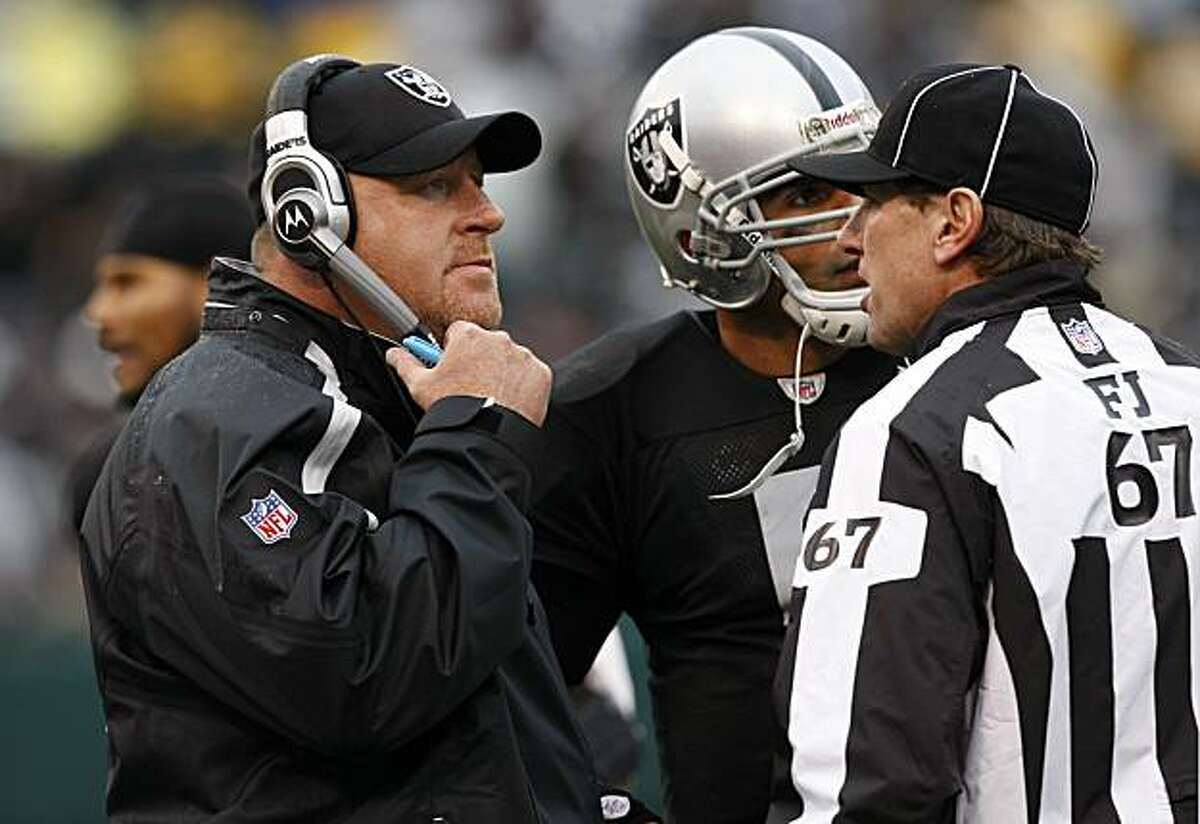 Raiders head coach Tom Cable and quarterback Bruce Gradkowski talk with umpire Doug Rosenbaum about a call Sunday in Oakland.