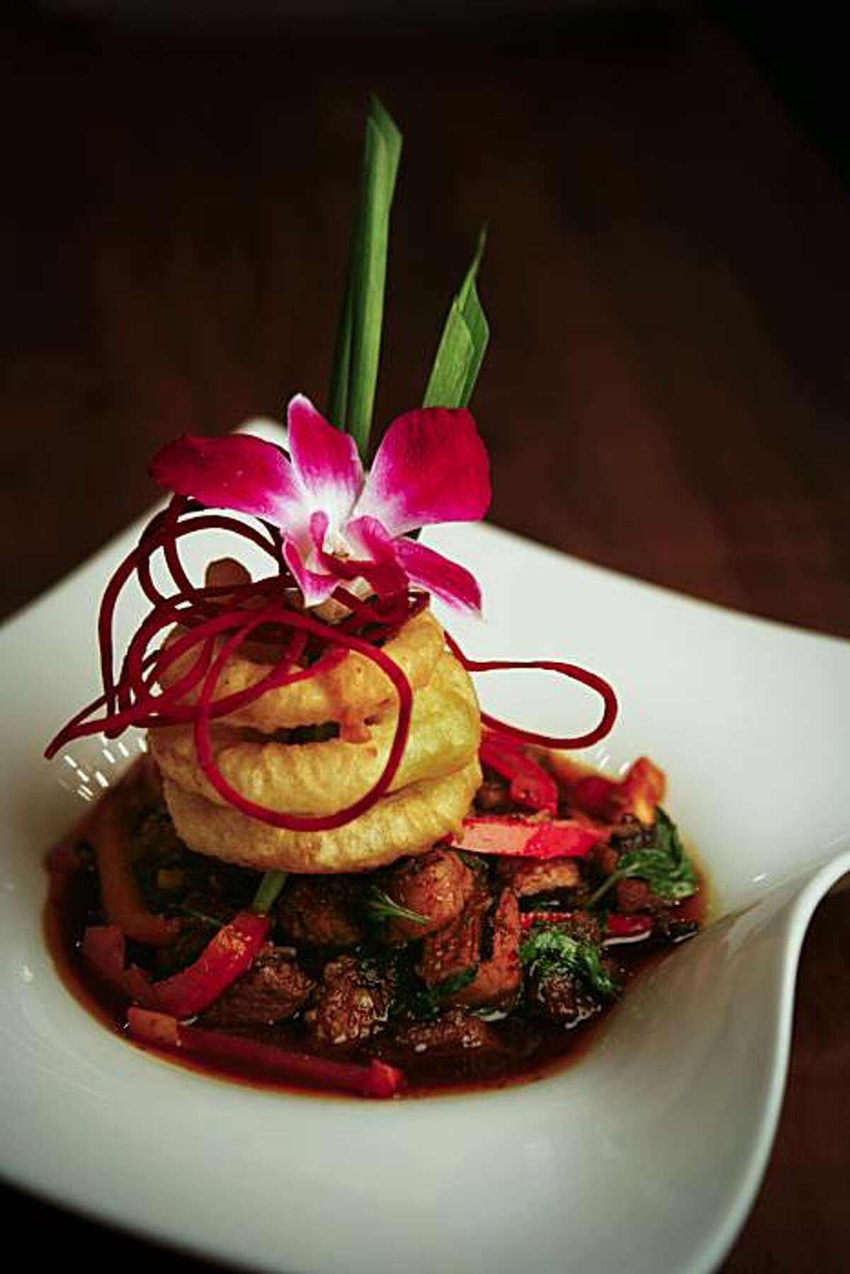 Volcanic Beef is Osha Thai Restaurant's signature dish. Sisters Laita Souksamlane and Wassana Korkhieola opened their first Osha Thai Restaurant in 1996. They will be opening their seventh location next week.
