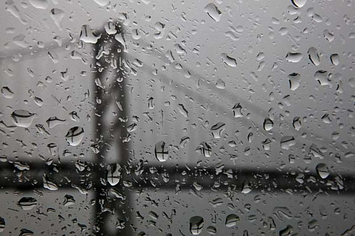 Raindrops on a window refract the image of the Bay Bridge during a rain storm on Tuesday.