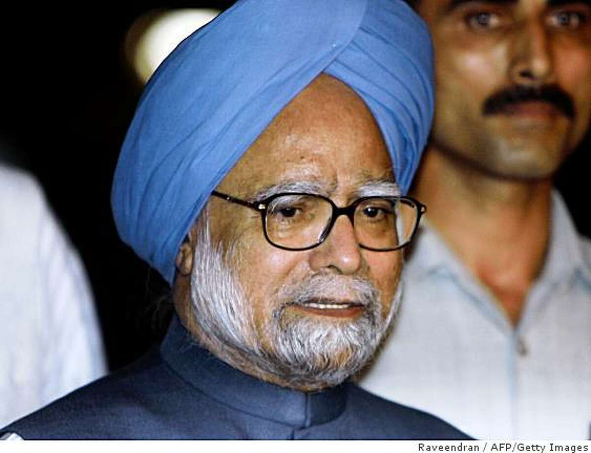 Indian Prime Minister Manmohan Singh talks to media representatives after the vote of confidence at Parliament house in New Delhi on July 22, 2008. India's embattled coalition government survived a chaotic parliamentary confidence vote, clearing the way for it to forge ahead with a civilian nuclear energy deal with the United States. AFP PHOTO/RAVEENDRAN (Photo credit should read RAVEENDRAN/AFP/Getty Images)