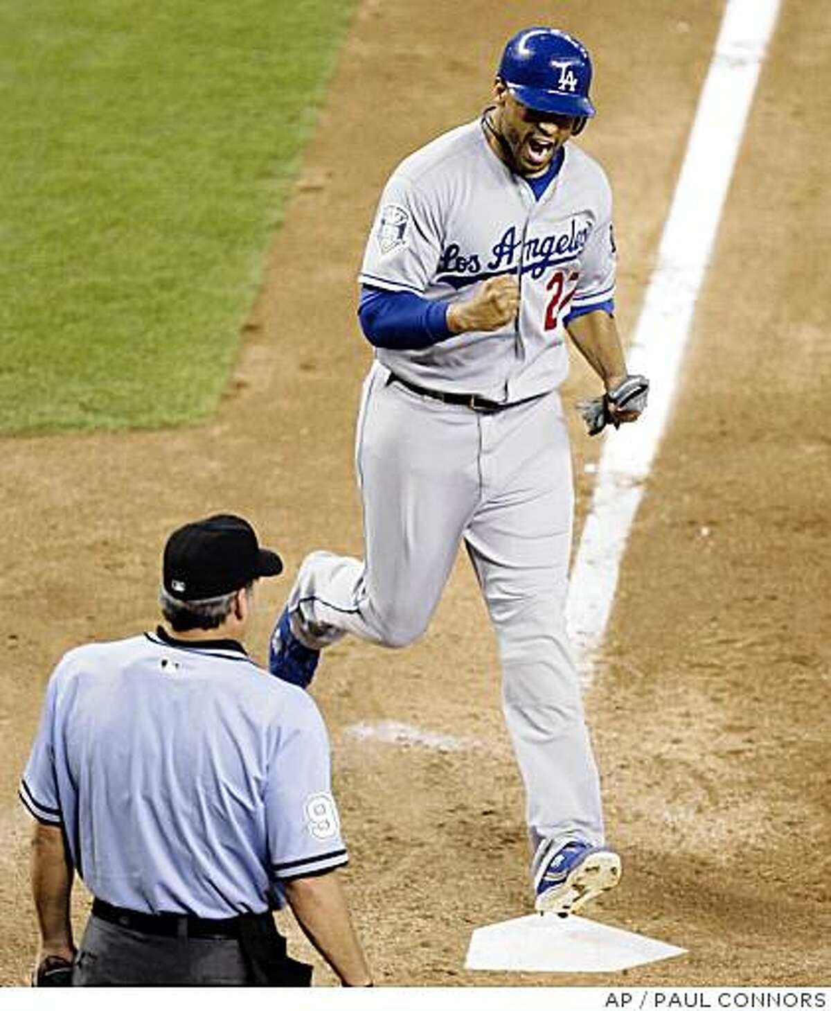Los Angeles Dodgers' Matt Kemp, top, pumps his fist as he crosses home plate on an RBI-single hit by teammate Andre Ethier off Arizona Diamondbacks closer Brandon Lyon in the ninth inning of a baseball game Sunday, July 20, 2008, in Phoenix. The Dodgers scored five runs in the ninth to win 6-5. (AP Photo/Paul Connors)