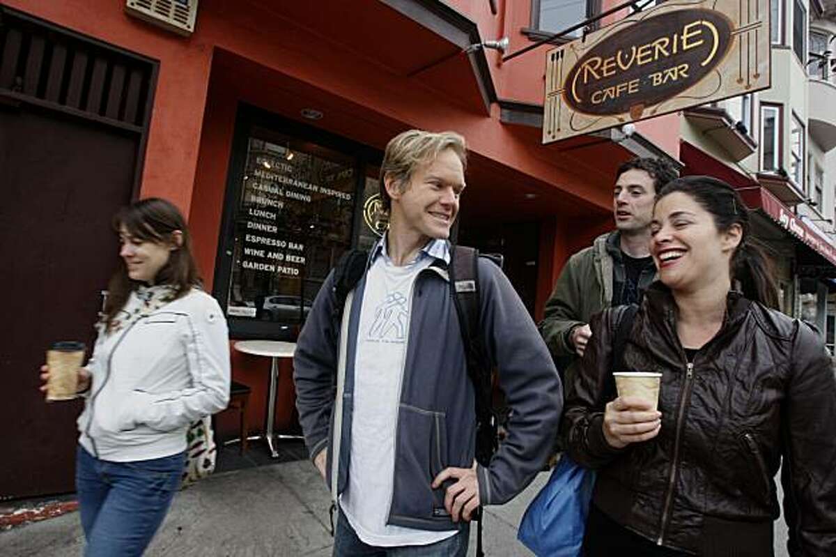 Thomas Vogl (middle) stops by Reverie coffee shop in Cole Valley and is joined by Beth Grinberg (right), Justin Westrum (back), and Sarah McNamara (left), as he walks 2 hours to his accounting job, from the outer sunset to SOMA in San Francisco, Calif., on Wednesday, November 11, 2009.