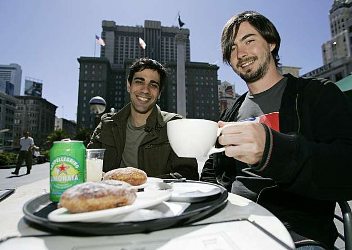 Jeremy Stoppelman, left, and Russel Simmons, right, co-founders of Yelp.com try the food at a cafe on Union Square in San Francisco, Calif., Monday, June 25, 2007. (AP Photo/Eric Risberg)