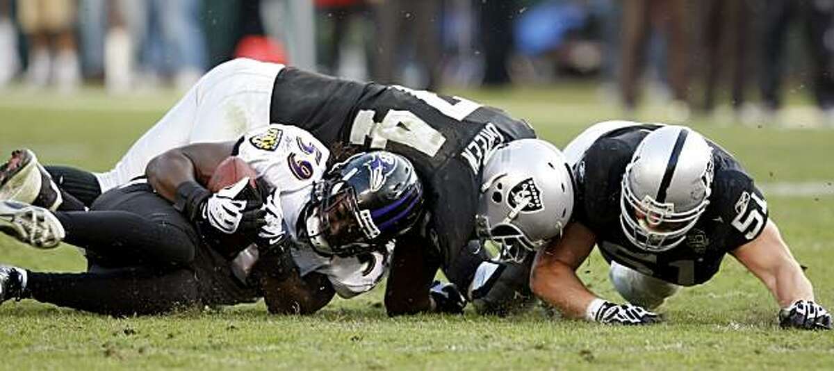The Baltimore Ravens' Dannell Ellerbe recovers a fumble by Oakland Raiders quarterback JaMarcus Russell in the fourth quarter Sunday in Oakland.