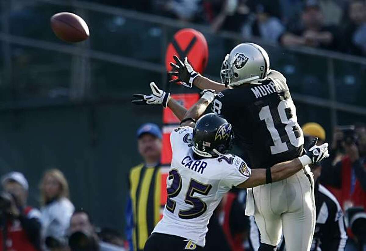The Oakland Raiders' Louis Murphy catches a first down pass in the second quarter against the Baltimore Ravens on Sunday in Oakland.