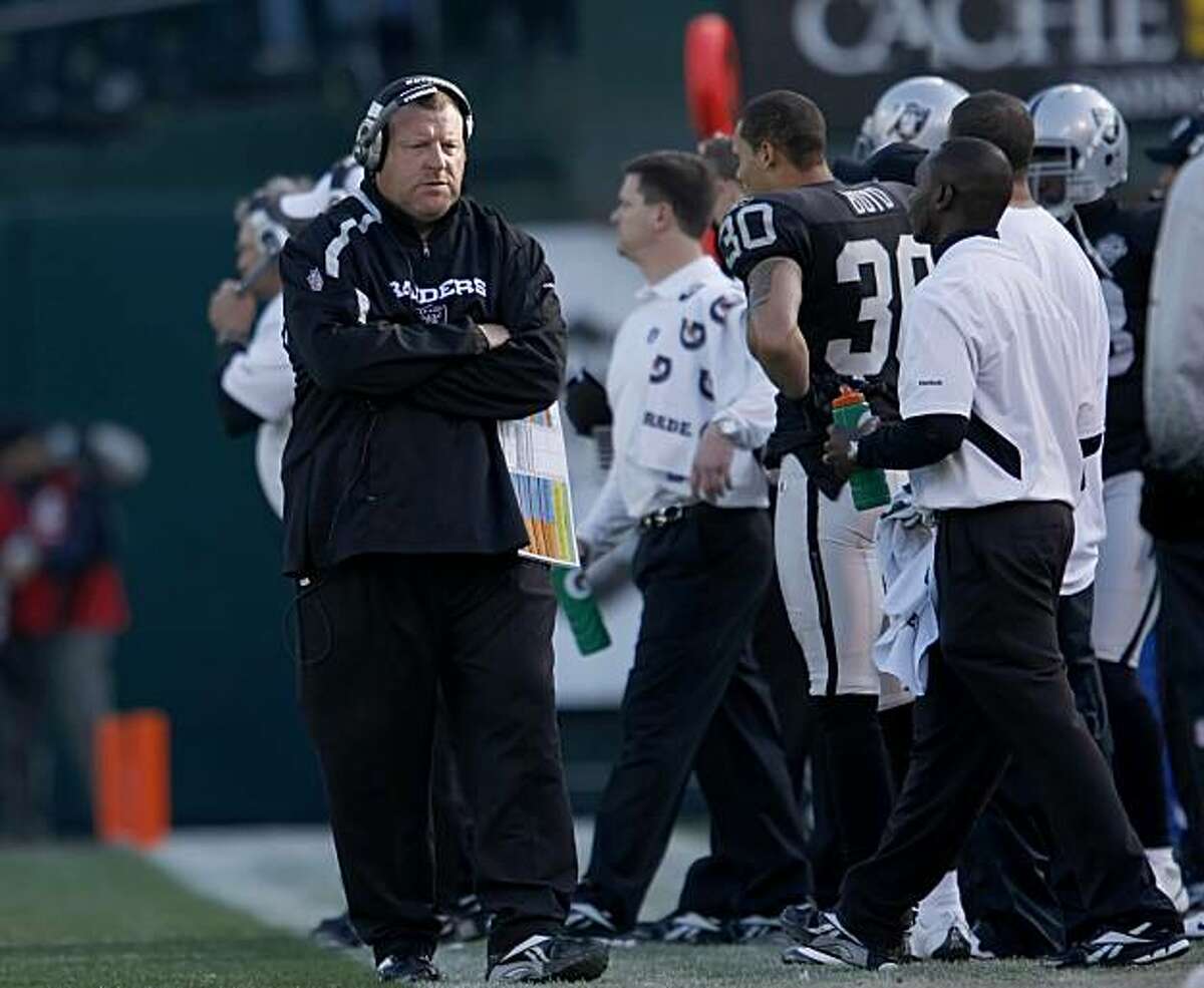 Oakland Raiders head coach Tom Cable walks the sidelines in the game against the Baltimore Ravens on Sunday in Oakland.