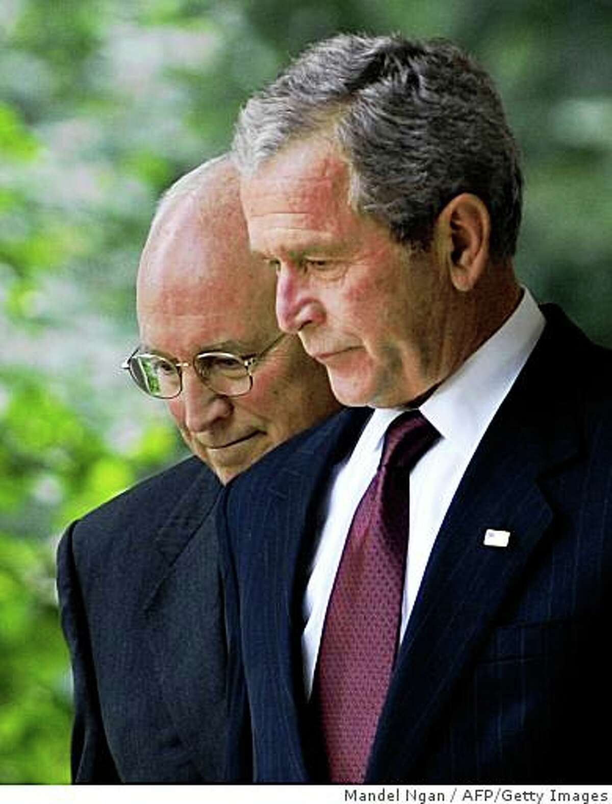 US President George W. Bush (R) and Vice President Dick Cheney walk to the Rose Garden on July 10, 2008 for Bush to sign H.R. 6304, the FISA Amendments Act of 2008, at the White House in Washington, DC. The bill would expand legal authority for electronic wiretaps by spy agencies and includes retroactive immunity for telecommunications firms which aided warrantless government surveillance operations following the September 11 attacks. AFP PHOTO/Mandel NGAN (Photo credit should read MANDEL NGAN/AFP/Getty Images)