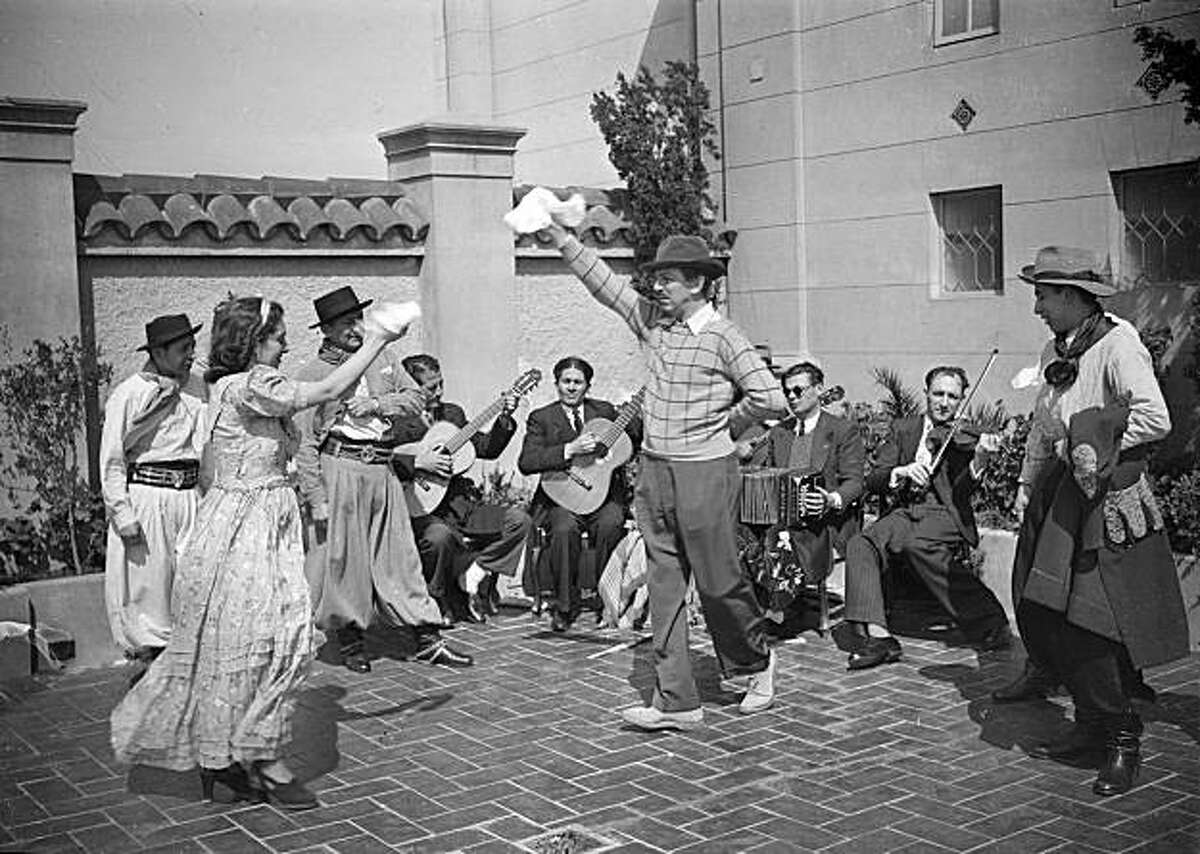 As part of the 1941 research trip to gather story material, Walt Disney joins the dancers from Andres Chazarreta's folkloric group on the rooftop of Buenos Aires' Alvear Palace Hotel. The dancer on the far right, Miguel Gramajo, was found during research and shares his memories of that afternoon in Walt & El Grupo.