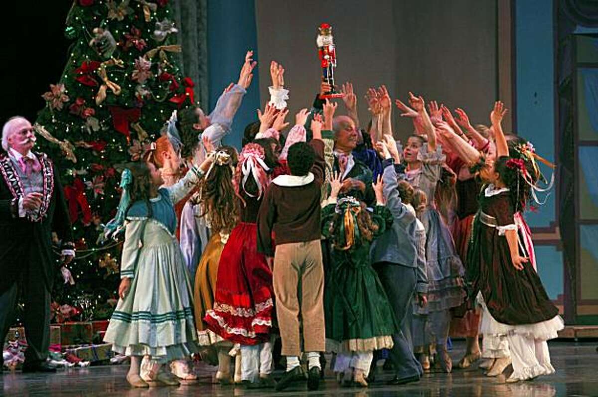 Carlos Carvajal ( center) shows off the nutcracker to the children in the cast of the Oakland Ballet's Nutcracker during the dress rehearsal, Wednesday Dec. 23, 2009, at the Paramount Theater in Oakland, Calif.