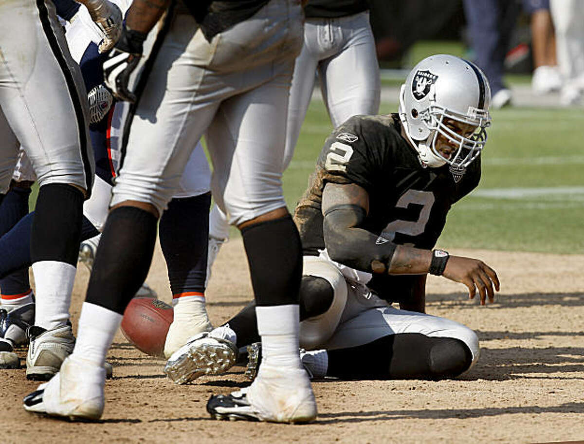 Raiders quarterback JaMarcus Russell gets to his feet after being sacked in the second half against the Broncos on Sunday.
