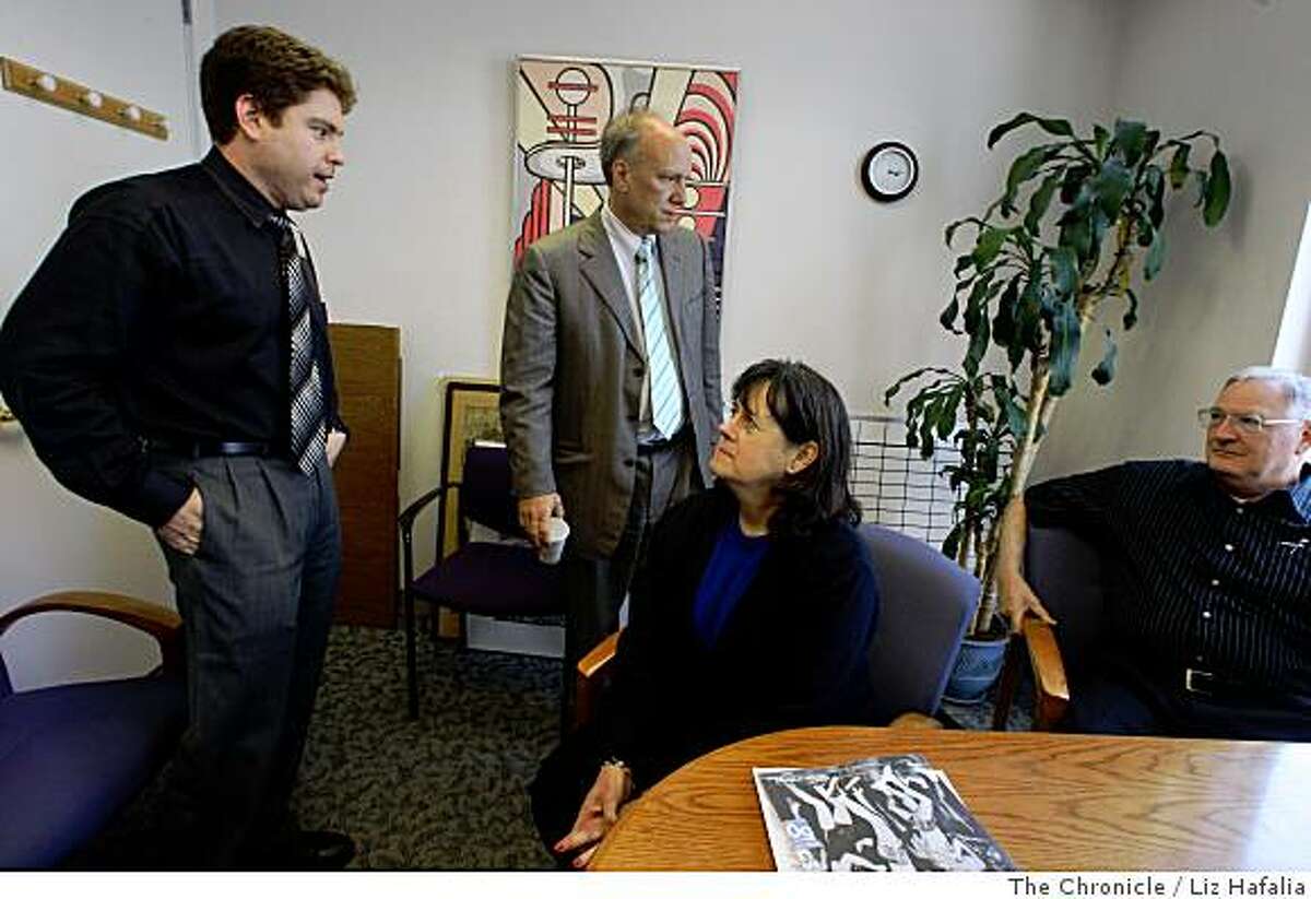 Neurologist Gil Rabinovici (left), MD, and director of UCSF Memory and Aging center Bruce Miller (standing, middle), MD, talk with Claudia Benedetti (seated), 61 years old, from Pacifica and her husband Allen Benedetti (seated) at UCSF on Monday, July 7, 2008. Trying to push for more early diagnosis of all forms of dementia Bruce Miller, MD, made the intiial diagnosis of Claudia who has early age of onset Alzheimer�s disease at UCSF in San Francisco, Calif.Photo by Liz Hafalia/The Chronicle