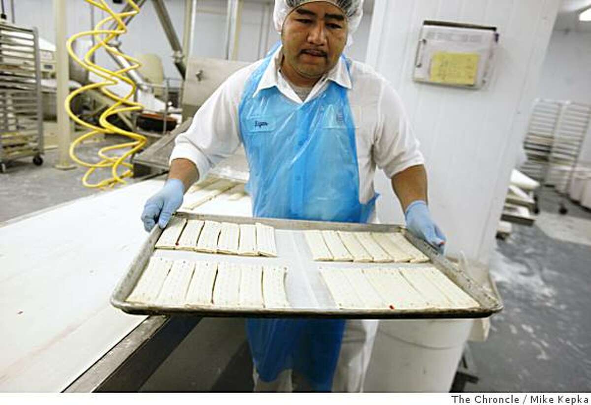 Edgar Quinteros preps a tray of Strudle Sticks for baking at the Sugar Bowl Bakery on Wednesday July 2, 2008 in San Francisco, Calif. Photo by Mike Kepka / The Chronicle