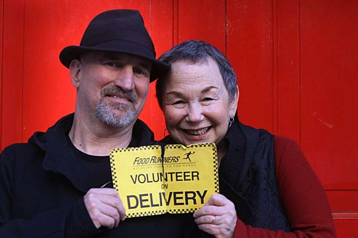 Nadie and Micki Meland (l to r), who have been volunteering with Food Runners for 20 years, are seen with the placard they use during food deliveries in San Francisco, Calif. on Tuesday December 22, 2009.