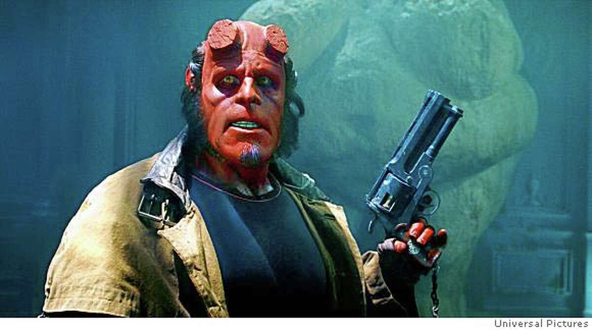 The world�s toughest, kitten-loving superhero, Hellboy (RON PERLMAN), prepares for duty in Hellboy II: The Golden Army. Credit: Universal Pictures