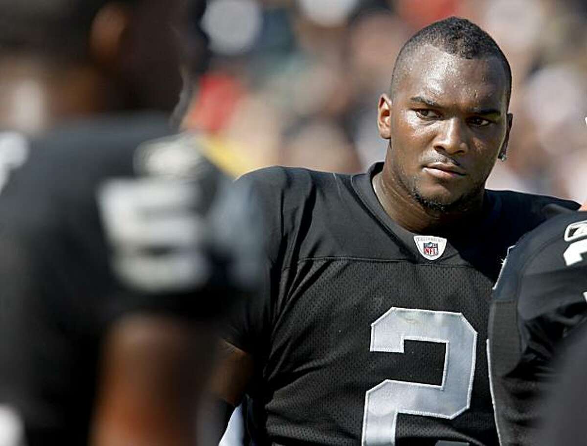 The Raiders' JaMarcus Russell returns to the sidelines after failing to move the ball Sunday against the Broncos.