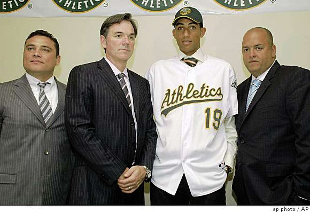 From left to right, Raymond Abreu, Oakland Athletics' director of Latin America operations, Billy Beane, Oakland Athletics' Vice President and General Manager, 16-year-old pitching prospect Michael Inoa and Edgar Mercedes, pose for the photographers after signing a contract in Santo Domingo, Wednesday, July 2, 2008. The Oakland Athletics and prized Dominican Michael Inoa agreed Wednesday to a minor league contract with a $4.25 million signing bonus. (AP Photo)
