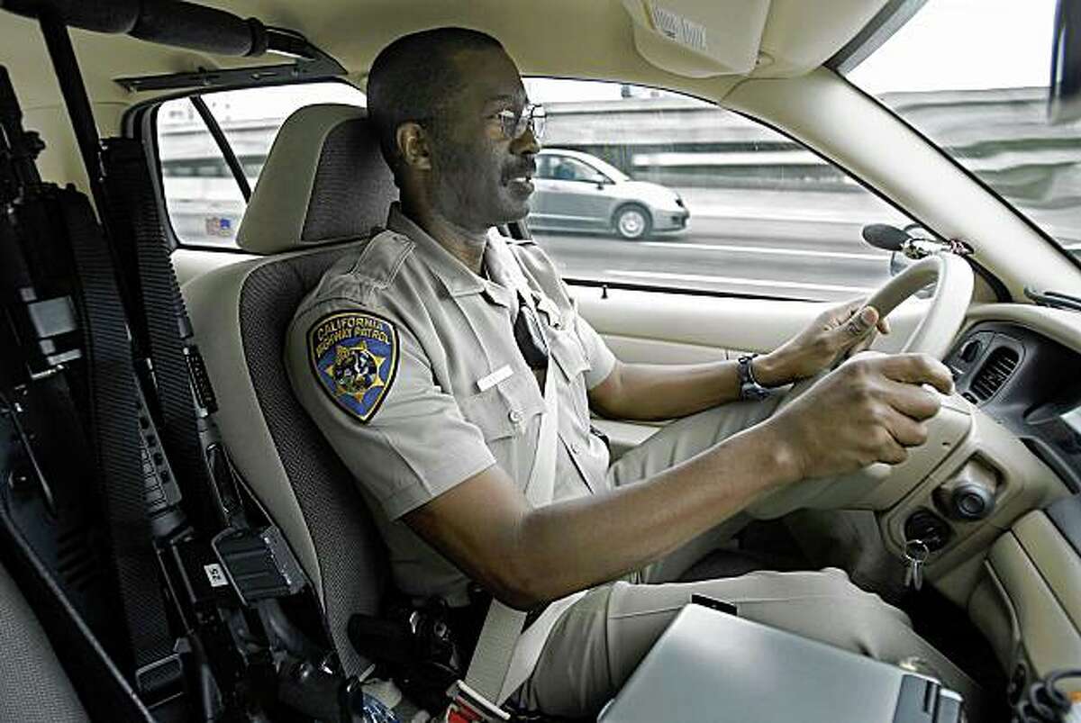 Sam Morgan an officer with the California Highway Patrol drives on highway 80 east bound through Berkeley looking for people talking on their cell phones without a hands free device on Tuesday, July 1, 2008 in Berkeley , Calif. Photo by Kurt Rogers / The Chronicle.