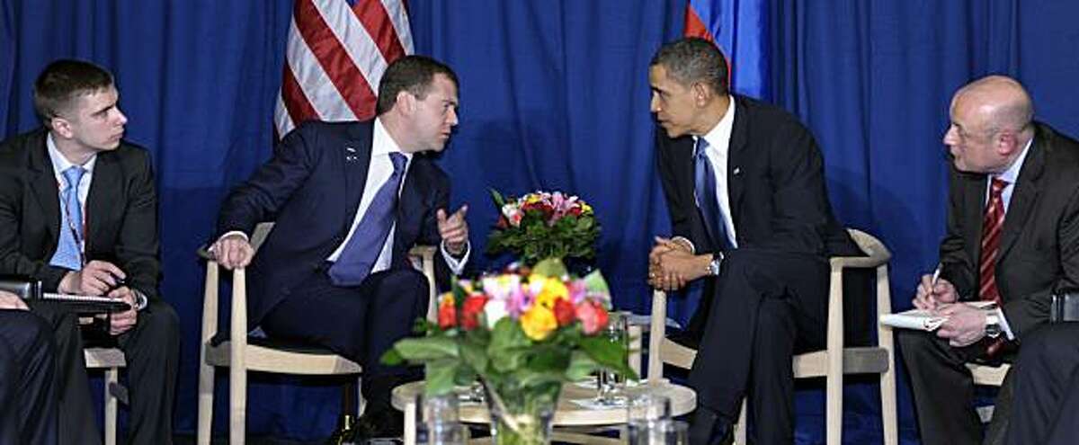 With translators on either side, President Barack Obama and Russian President Dmitry Medvedev talk during a meeting at the United Nations Climate Change Conference at the Bella Center in Copenhagen, Denmark, Friday, Dec. 18, 2009. (AP Photo/Susan Walsh)