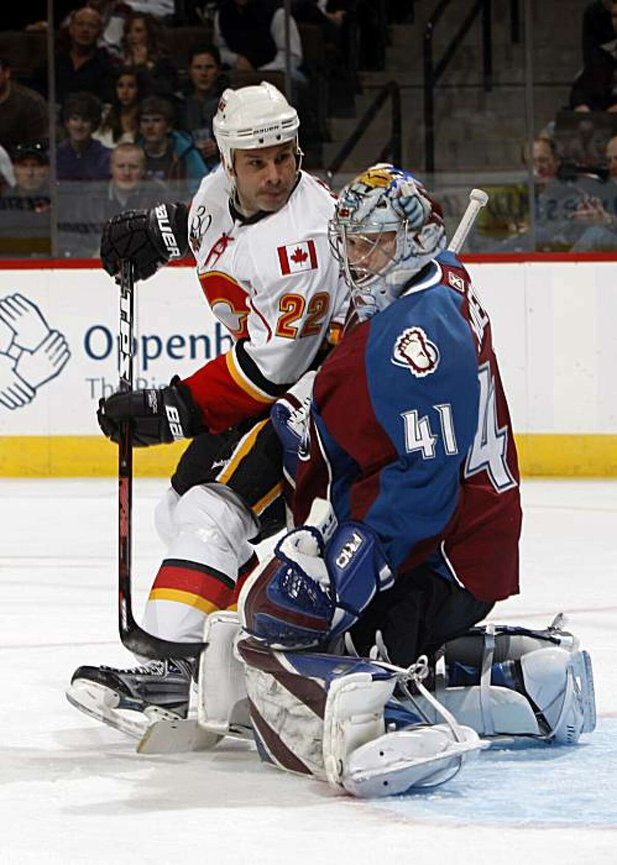 Calgary Flames center Daymond Langkow, left, has his shot stopped by Colorado Avalanche goalie Craig Anderson in the second period of an NHL hockey game in Denver on Sunday, Dec. 13, 2009. (AP Photo/David Zalubowski)