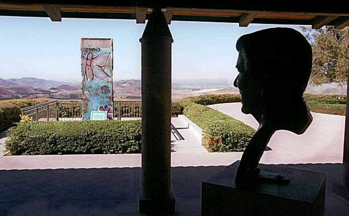 SIMI VALLEY, Calif. -- A bust of former U.S. President Ronald Reagan, by the artist Donald Winton, appears to gaze out upon a section of the Berlin Wall which resides on the grounds of the Ronald Reagan Presidential Library in Simi Valley, Calif., Oct. 13, 1999. The section ofwall was donated to the library in April 1990. (AP Photo/Chris Pizzello)