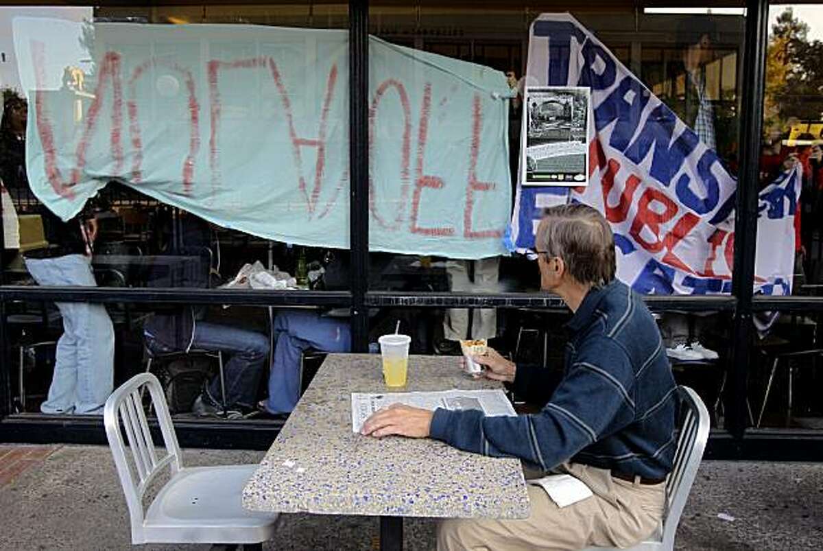 Toxicology professor Len Bjeldanes watches protesters hang banners inside the Bear's Lair food court at UC Berkeley, Calif., on Wednesday, Dec. 2, 2009.