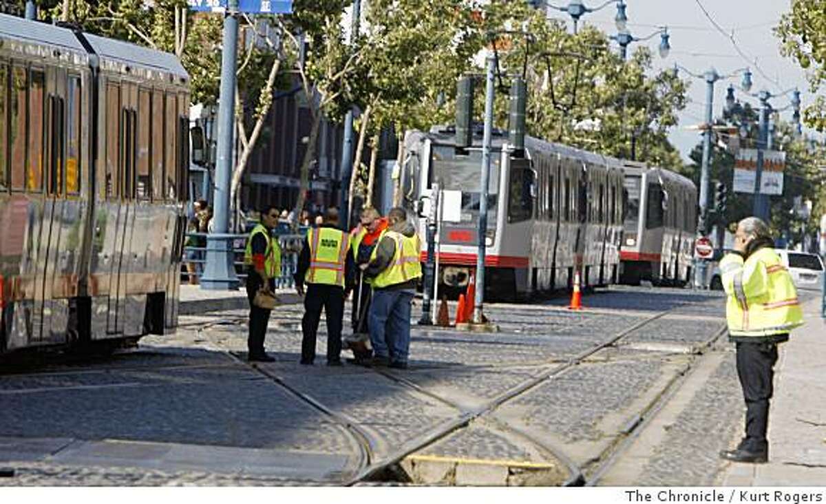 Workers clean up after a MUNI accident at 4th and King St in front of AT&T Park on Saturday, June 14, 2008 in San Francisco , Calif Photo by Kurt Rogers / The Chronicle.
